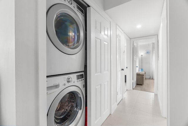 1150 NW 13th St Unit 172C, Boca Raton, FL 33486 - laundry room featuring stacked washing machine and dryer, light tile patterned floors, and baseboards
