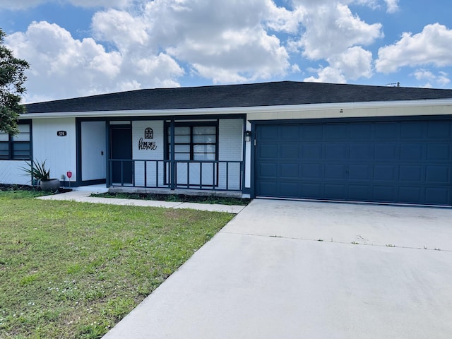 single story home with driveway, a front yard, an attached garage, and covered porch