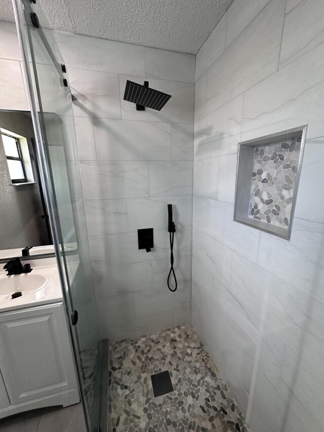 574 NW Marion Ave, Port Saint Lucie, FL 34983 - full bath featuring a stall shower, vanity, and a textured ceiling