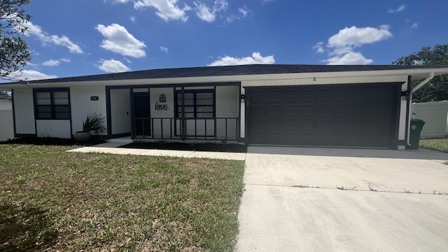574 NW Marion Ave, Port Saint Lucie, FL 34983 - single story home featuring concrete driveway, a garage, a front lawn, and covered porch