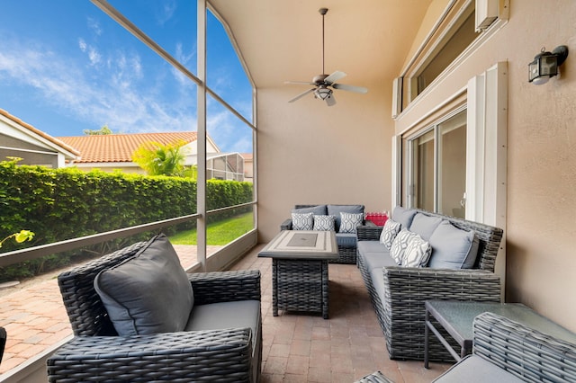 sunroom / solarium featuring a ceiling fan and an outdoor hangout area