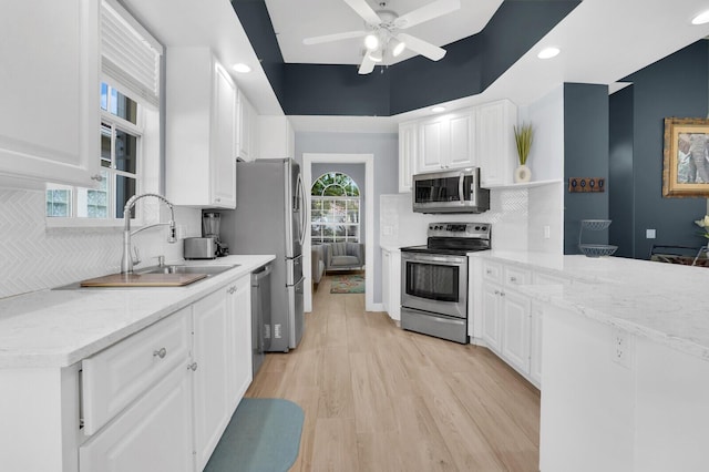 7816 Red River Rd, West Palm Beach, FL 33411 - kitchen with stainless steel appliances, a sink, white cabinetry, open shelves, and recessed lighting