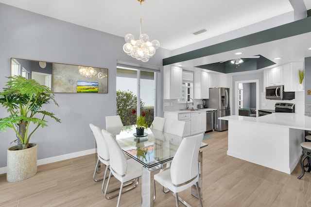 7816 Red River Rd, West Palm Beach, FL 33411 - dining area featuring light wood finished floors, a chandelier, and baseboards