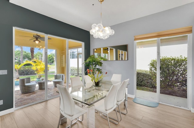 7816 Red River Rd, West Palm Beach, FL 33411 - dining space featuring light wood-type flooring, a ceiling fan, baseboards, and a chandelier