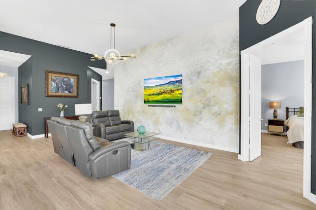 7816 Red River Rd, West Palm Beach, FL 33411 - living room with a chandelier, wood finished floors, an accent wall, and baseboards