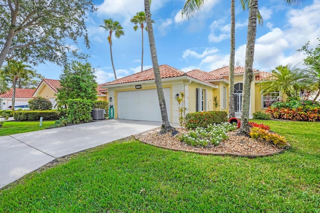 7816 Red River Rd, West Palm Beach, FL 33411 - mediterranean / spanish house with a tile roof, cooling unit, stucco siding, an attached garage, and a front lawn