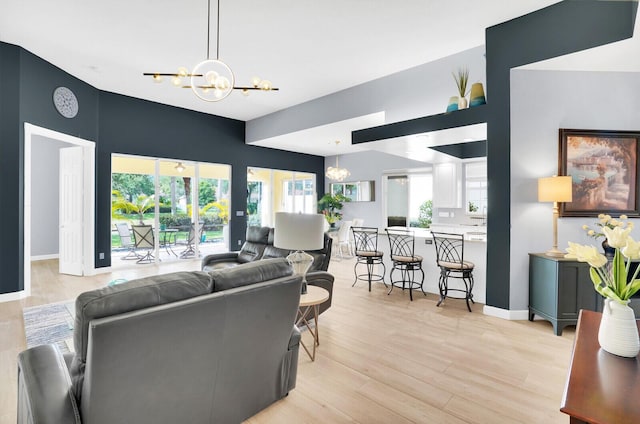 7816 Red River Rd, West Palm Beach, FL 33411 - living room featuring a chandelier, light wood-type flooring, and baseboards