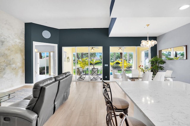 7816 Red River Rd, West Palm Beach, FL 33411 - dining space with a chandelier, light wood-style flooring, a ceiling fan, and french doors