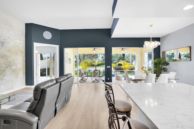 7816 Red River Rd, West Palm Beach, FL 33411 - dining room featuring plenty of natural light, a chandelier, light wood-style flooring, and a ceiling fan