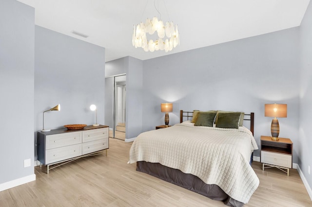 7816 Red River Rd, West Palm Beach, FL 33411 - bedroom featuring baseboards, a chandelier, wood finished floors, and a closet