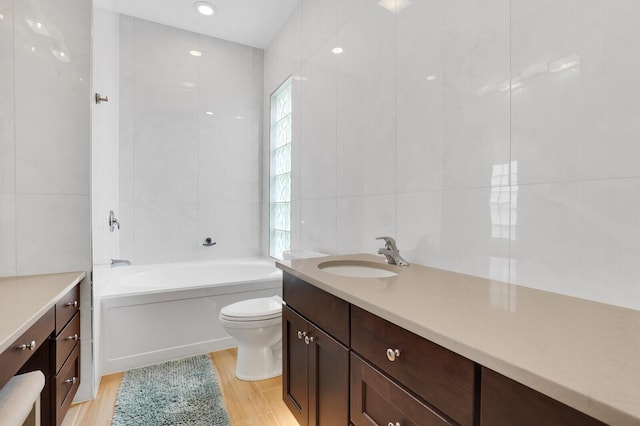 7816 Red River Rd, West Palm Beach, FL 33411 - full bathroom featuring wood finished floors, a tub, toilet, tile walls, and vanity