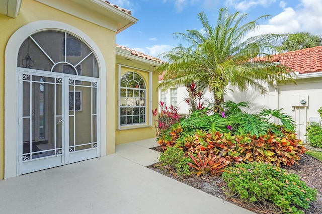 7816 Red River Rd, West Palm Beach, FL 33411 - property entrance featuring a tile roof and stucco siding
