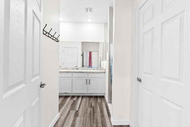 2509 SW Kenilworth St, Port Saint Lucie, FL 34953 - full bath featuring wood finished floors, vanity, and baseboards