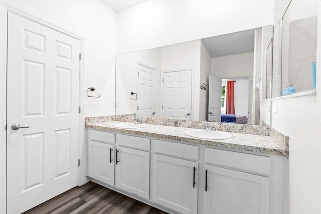 2509 SW Kenilworth St, Port Saint Lucie, FL 34953 - full bath with double vanity, connected bathroom, and wood finished floors