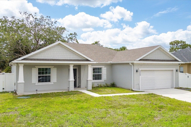 2509 SW Kenilworth St, Port Saint Lucie, FL 34953 - view of front of home with a garage, driveway, stucco siding, a porch, and a shingled roof