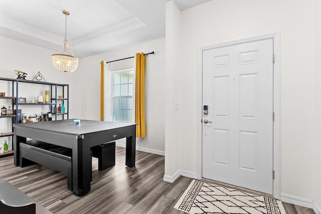 2509 SW Kenilworth St, Port Saint Lucie, FL 34953 - recreation room with wood finished floors, a chandelier, baseboards, a raised ceiling, and crown molding