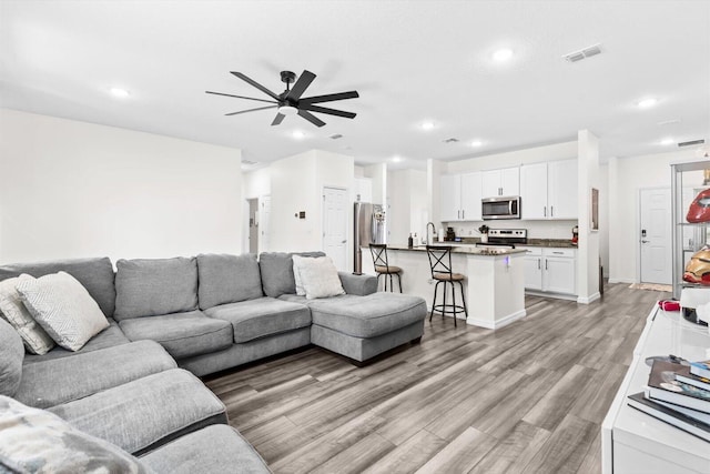 2509 SW Kenilworth St, Port Saint Lucie, FL 34953 - living area featuring ceiling fan, light wood-style floors, recessed lighting, and baseboards