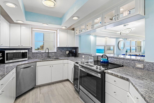3000 S Ocean Blvd Unit 6010, Boca Raton, FL 33432 - kitchen featuring stainless steel appliances, a sink, healthy amount of natural light, and white cabinetry