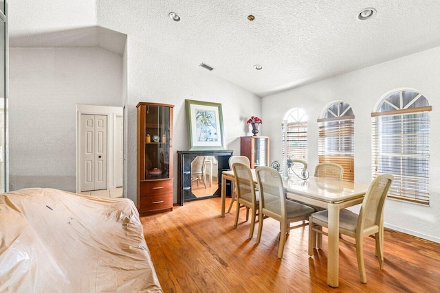 9023 Seminole Pratt Whitney Rd, The Acreage, FL 33470 - dining room with lofted ceiling, light wood-style floors, and a textured ceiling