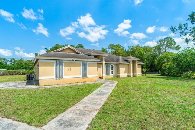 9023 Seminole Pratt Whitney Rd, The Acreage, FL 33470 - ranch-style home with stucco siding, a front lawn, and cooling unit
