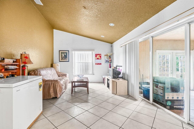 9023 Seminole Pratt Whitney Rd, The Acreage, FL 33470 - living room featuring vaulted ceiling, light tile patterned floors, and a textured ceiling