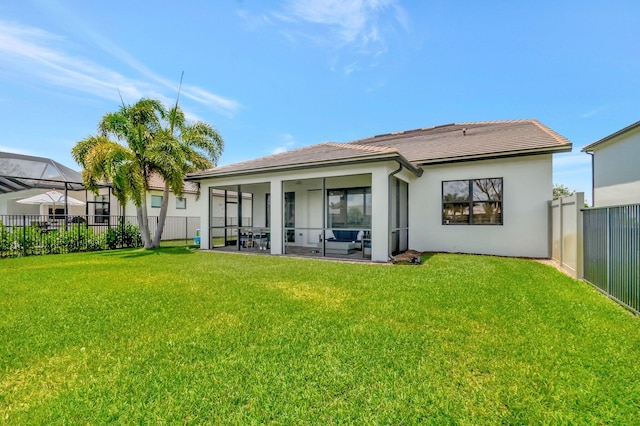 4646 Eventing St, Lake Worth, FL 33467 - back of house with a fenced backyard, stucco siding, a tiled roof, and a sunroom