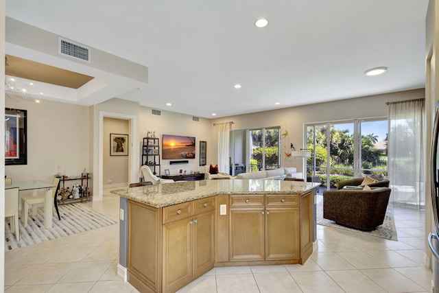 kitchen featuring open floor plan, light tile patterned flooring, light stone countertops, and recessed lighting