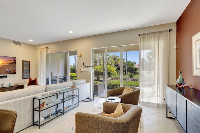 living area featuring light tile patterned floors and recessed lighting