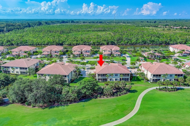 aerial view of residential area featuring a forest