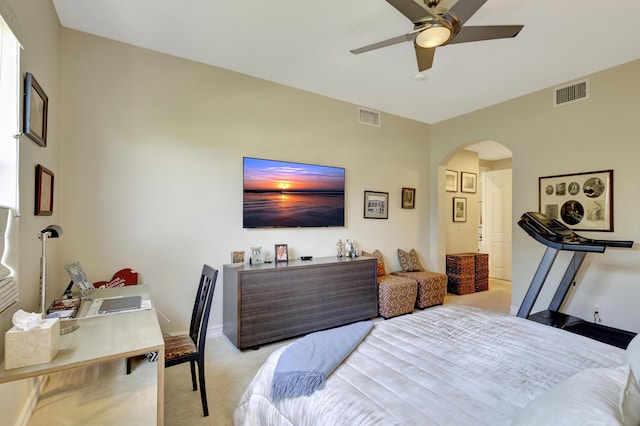 bedroom with arched walkways, light colored carpet, a ceiling fan, and baseboards