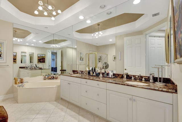 full bathroom with a raised ceiling, a shower stall, tile patterned floors, and a chandelier