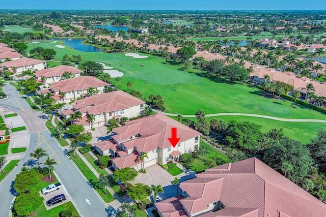 aerial view of residential area featuring a large body of water and a golf club