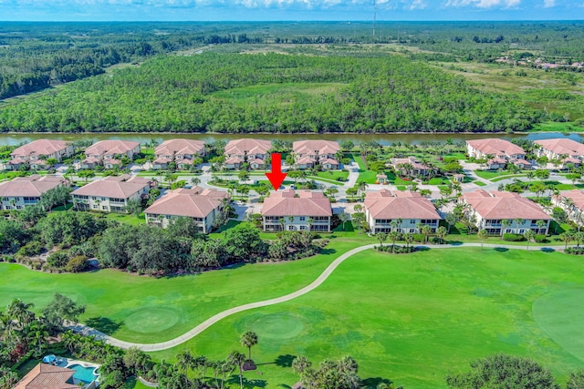 aerial view of residential area with a large body of water, a heavily wooded area, and a golf course