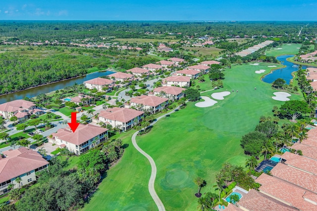 aerial perspective of suburban area featuring a large body of water and a golf course