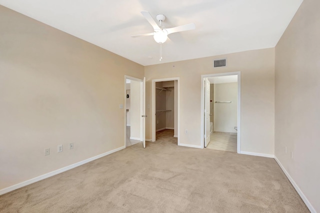 6510 Emerald Dunes Dr Unit 302, West Palm Beach, FL 33411 - unfurnished bedroom featuring light carpet, baseboards, a walk in closet, a closet, and ensuite bath