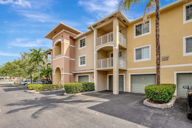 6510 Emerald Dunes Dr Unit 302, West Palm Beach, FL 33411 - view of building exterior featuring a garage