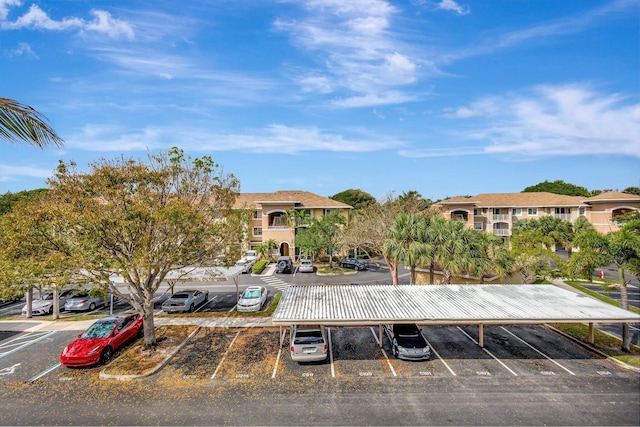 6510 Emerald Dunes Dr Unit 302, West Palm Beach, FL 33411 - view of building exterior featuring uncovered parking