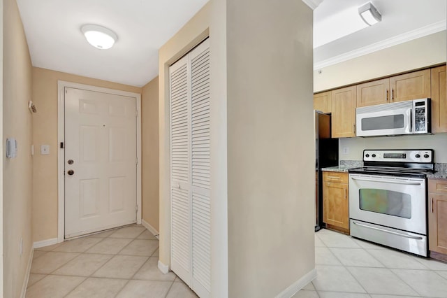6510 Emerald Dunes Dr Unit 302, West Palm Beach, FL 33411 - kitchen with stainless steel appliances, baseboards, light tile patterned floors, and ornamental molding