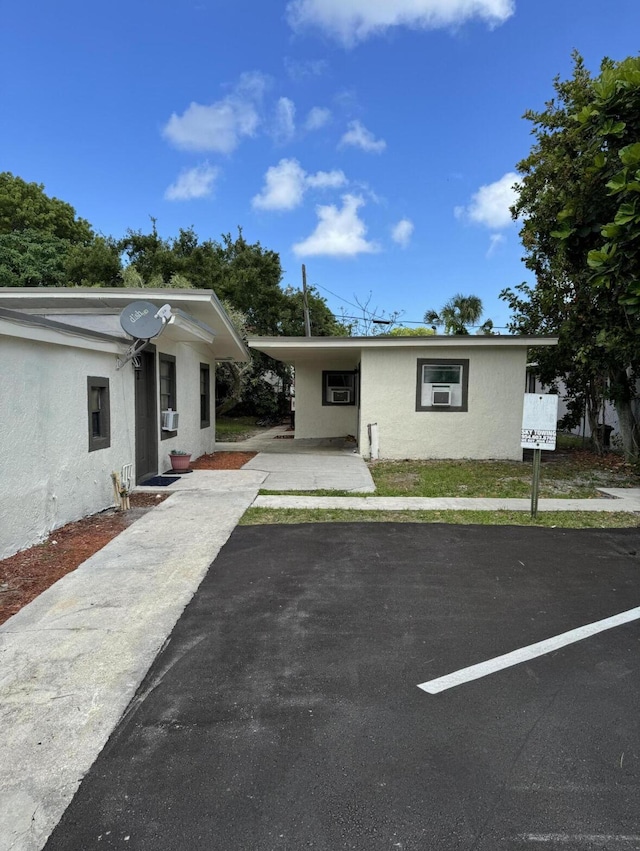 626 NW 10th Ter Unit 1-5, Fort Lauderdale, FL 33311 - view of front of home with stucco siding, driveway, and cooling unit