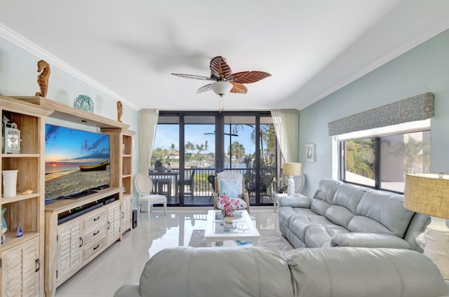 living room featuring crown molding, a ceiling fan, and plenty of natural light