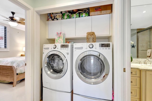 washroom with washing machine and dryer, cabinet space, a ceiling fan, and recessed lighting
