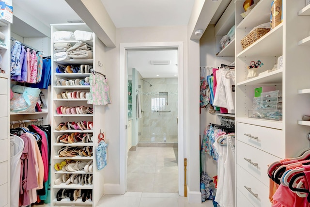 walk in closet with tile patterned floors