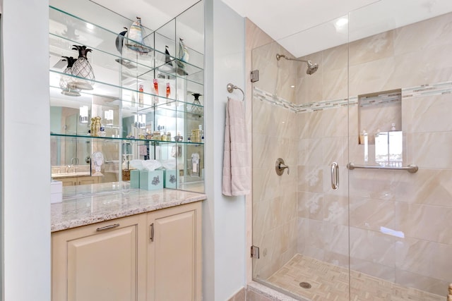 full bath featuring a stall shower and vanity