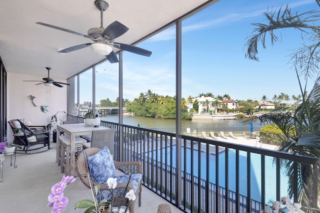sunroom / solarium featuring a water view
