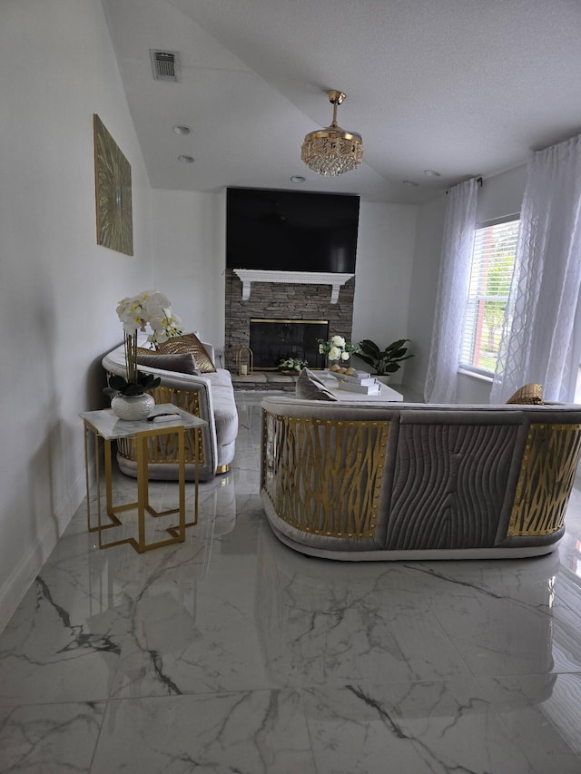 living area with a stone fireplace, baseboards, and marble finish flooring