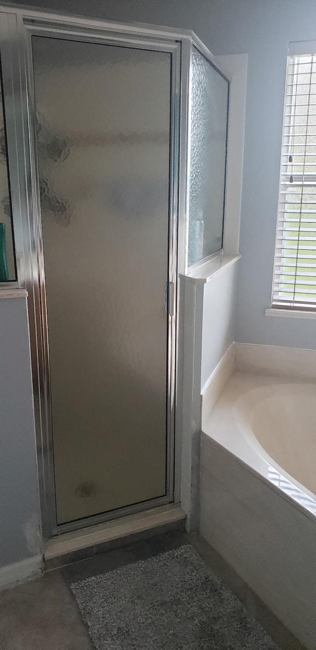 full bathroom with a garden tub and a shower stall
