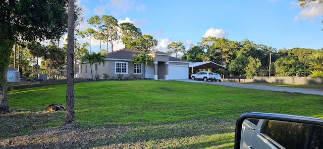 14413 71st Pl N, Loxahatchee, FL 33470 - ranch-style house with a carport, a front yard, stucco siding, an attached garage, and driveway