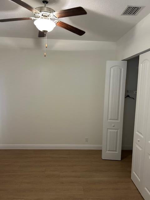 14413 71st Pl N, Loxahatchee, FL 33470 - empty room featuring wood finished floors, baseboards, and a ceiling fan
