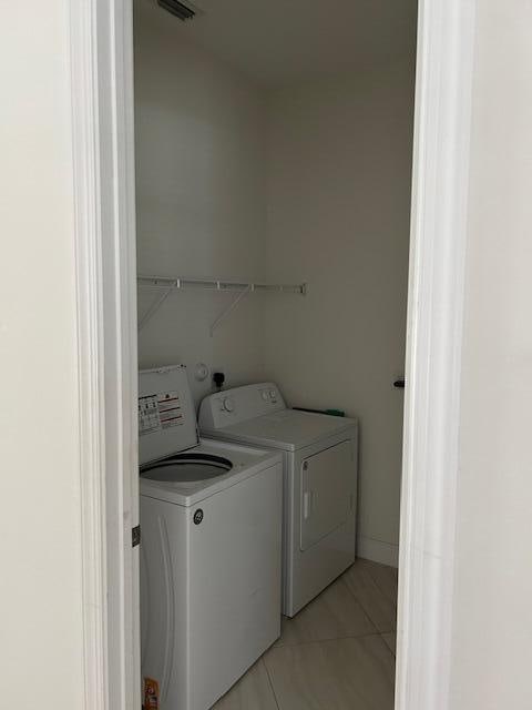 14413 71st Pl N, Loxahatchee, FL 33470 - clothes washing area with independent washer and dryer and light tile patterned flooring