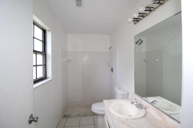 1561 SE Arenson Ln, Port Saint Lucie, FL 34952 - full bathroom with toilet, a tile shower, vanity, and tile patterned flooring